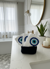 Load image into Gallery viewer, Three white towels with evil eye designs in bathroom setting