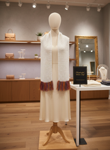 Load image into Gallery viewer, White crochet winter scarf with multicolor fringe on mannequin in boutique