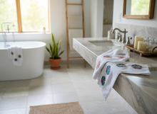 Load image into Gallery viewer, White towels with crochet flowers in bathroom setting