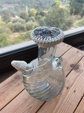 Load image into Gallery viewer, A clear glass water jug with a crochet cover