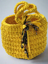 Load image into Gallery viewer, Yellow woven basket with a handle on a gray background