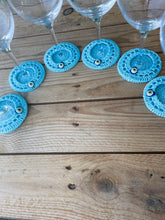 Load image into Gallery viewer, Wine glasses with blue crocheted coasters on a wooden surface
