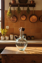 Load image into Gallery viewer, A Lebanese ibriq or water jug with a dark brown crochet cover with an acorn in a traditional kitchen

