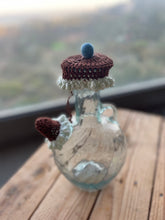 Load image into Gallery viewer, Small glass jar with a knitted lid on a wooden surface

