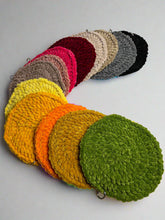 Load image into Gallery viewer, Stack of colorful crocheted glasses covers on a white background
