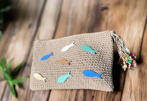 Handmade bag with fish patterns on a wooden surface