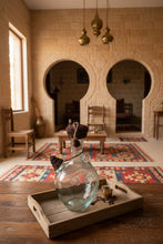 Load image into Gallery viewer, Lebanese Water Jug with a crochet cover with an acorn in a traditional Lebanese house 
