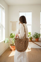 Load image into Gallery viewer, Brown crochet bag held by a person 
