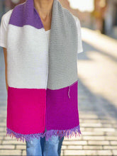 Load image into Gallery viewer, Colorful striped scarf held by a person on a wooden floor.
