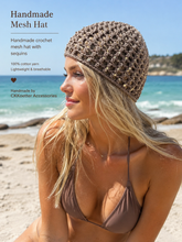 Load image into Gallery viewer, Woman wearing a handmade crochet mesh hat with sequins on a beach.
