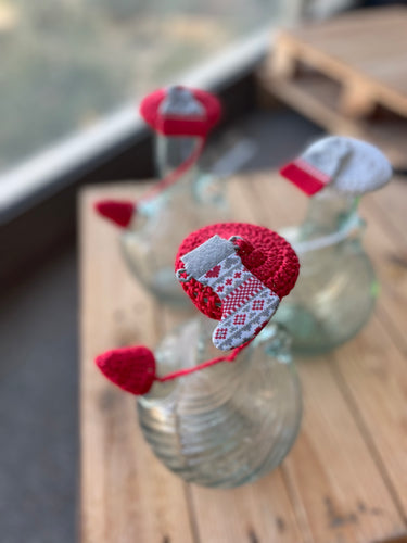 Decorative heart-shaped object on a glass surface with a blurred background