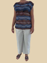 Load image into Gallery viewer, Person wearing a striped sleeveless top and light-colored pants on a tiled floor.
