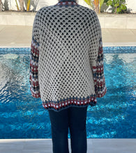 Load image into Gallery viewer, Person wearing a patterned sweater by a pool
