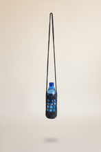 Load image into Gallery viewer, Blue bottle in a black crocheted holder against a white background
