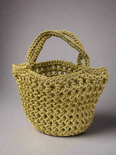 Load image into Gallery viewer, Gold knitted bag on a stone surface with natural elements
