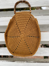 Load image into Gallery viewer, Brown crochet bag with bamboo handle on a sandy beach

