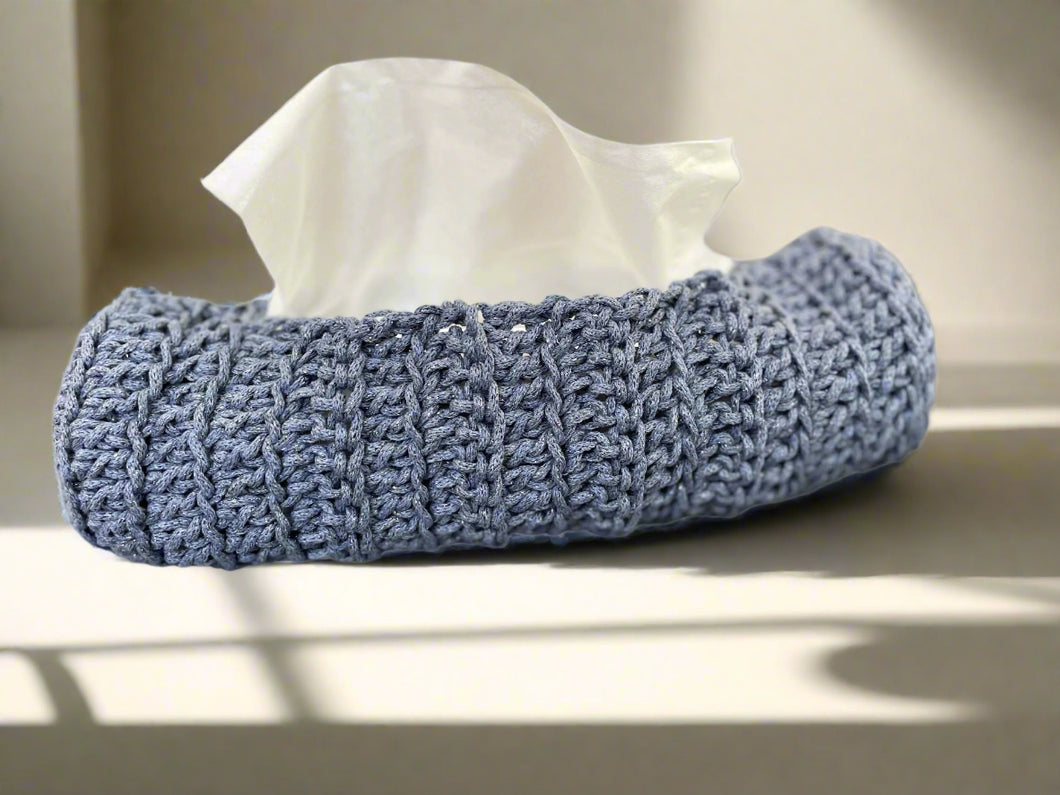 Knitted tissue holder with tissues on a gray surface