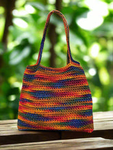 Load image into Gallery viewer, Colorful crocheted bag hanging on a tree branch
