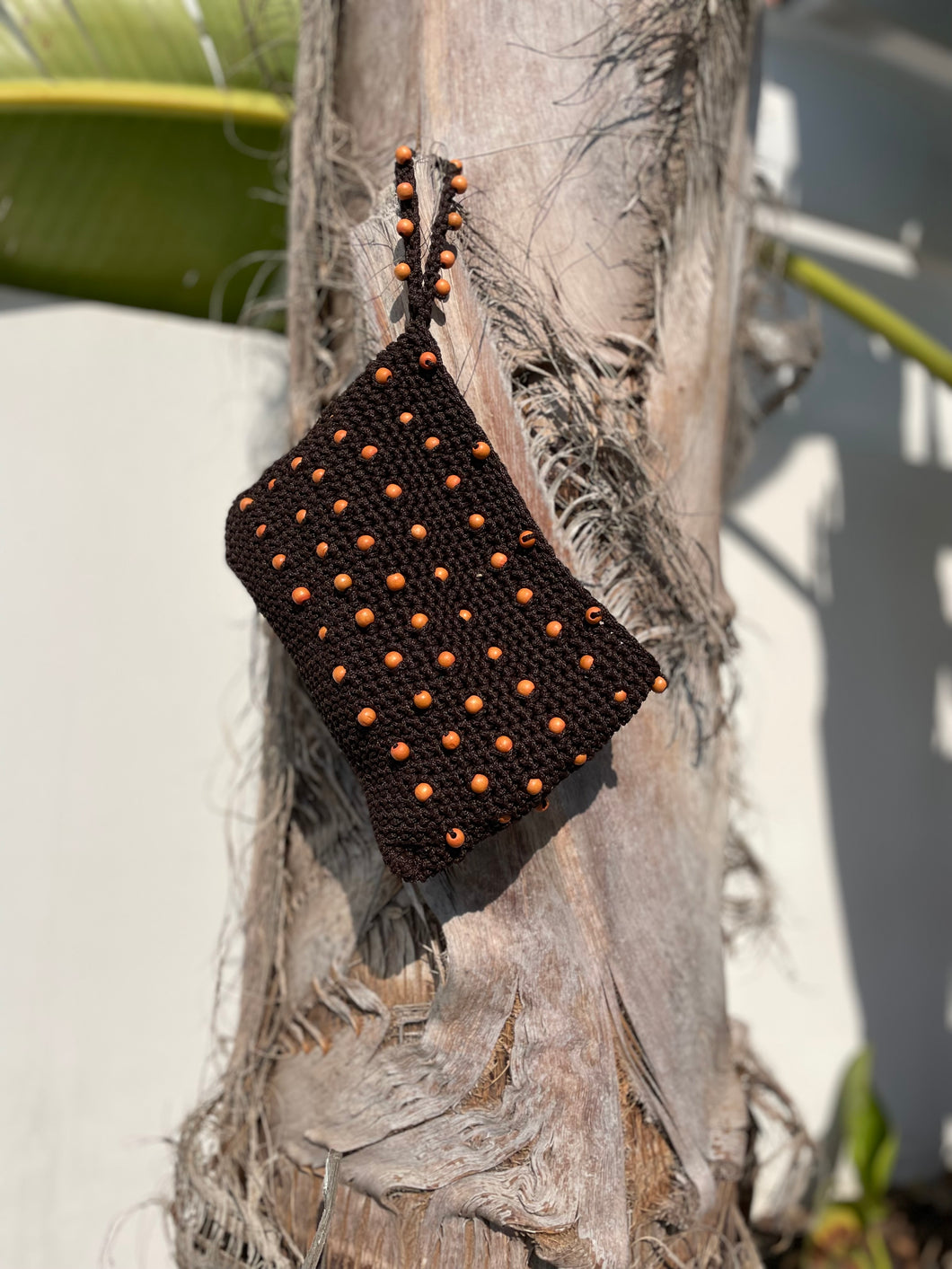 Brown woven pouch with orange beads 