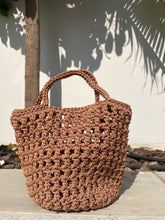 Load image into Gallery viewer, Brown woven handbag against a light background
