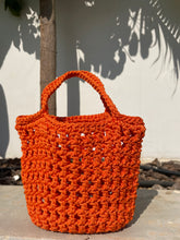 Load image into Gallery viewer, Orange crochet bag against a light background
