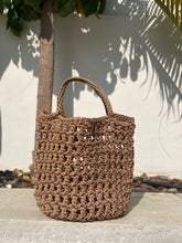 Load image into Gallery viewer, Brown woven handbag on a light background
