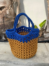 Load image into Gallery viewer, Two-toned blue and brown crocheted bag on a textured surface
