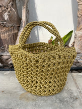 Load image into Gallery viewer, Gold knitted bag on a stone surface with natural elements

