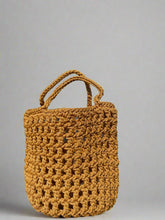 Load image into Gallery viewer, Brown woven handbag on a light surface with shadows

