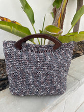 Load image into Gallery viewer, Textured handbag with a wooden handle on a light background
