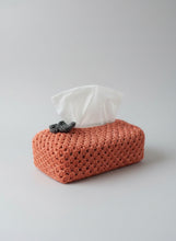 Load image into Gallery viewer, Crocheted orange tissue holder with a white tissue on a wooden surface
