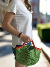 Load image into Gallery viewer, Person holding a green crochet bag outdoors
