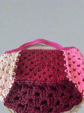 Load image into Gallery viewer, Crocheted bag with pink, red, and white sections on a light background
