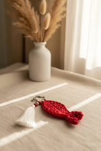 Load image into Gallery viewer, Red crocheted keychain with a star-shaped keyring and white tassel on a gray background
