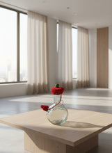 Load image into Gallery viewer, Clear glass bottle with a red crochet cherry on top against a light gray tiled background
