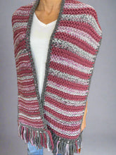 Load image into Gallery viewer, Striped knitted scarf with tassels on a wooden floor background
