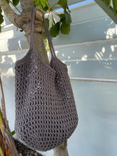 Load image into Gallery viewer, Crocheted bag with a textured pattern on a white background
