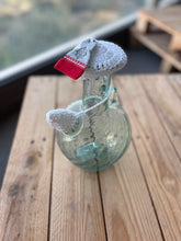 Load image into Gallery viewer, Decorative glass bottle with a red and white tag on a wooden surface
