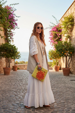 Load image into Gallery viewer, yellow crocheted bag with an orange floral charm 
