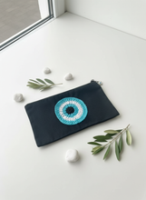 Load image into Gallery viewer, Black pouch with colorful circular crochet design on white background
