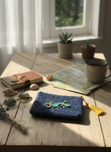 Load image into Gallery viewer, Crochet wallet with gecko badge and yellow tassel lifestyle background
