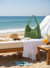 Load image into Gallery viewer, Green raffia crochet bag on beach sun bed
