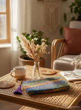 Load image into Gallery viewer, Lifestyle background with colorful crochet pouch
