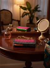 Load image into Gallery viewer, Multicolored crochet clutch flat in elegant evening setting

