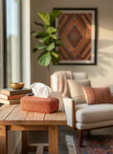 Load image into Gallery viewer, Orange metallic crochet tissue box cover displayed in warm home interior with natural lighting
