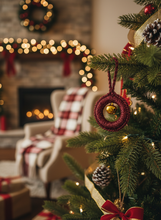 Load image into Gallery viewer, Red shimmery crochet Christmas ornament with golden bell lifestyle background
