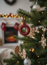 Load image into Gallery viewer, Red shimmery crochet Christmas ornament with silver bell on tree
