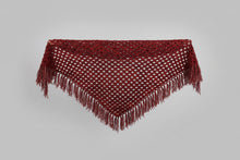 Load image into Gallery viewer, Person standing behind a red tablecloth-covered table with a Christmas tree in the background
