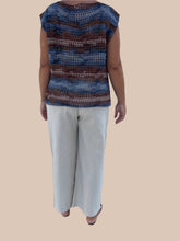Load image into Gallery viewer, Person wearing a striped sleeveless top and beige pants standing on a tiled floor.
