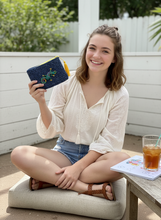 Load image into Gallery viewer, Teenager holding crochet wallet with gecko badge and yellow tassel
